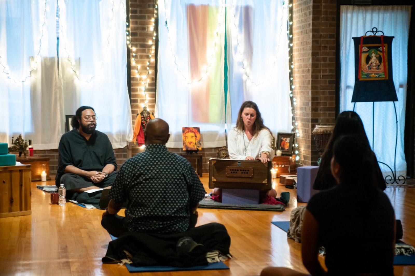 Hope Littwin at the harmonium, leading a ceremony